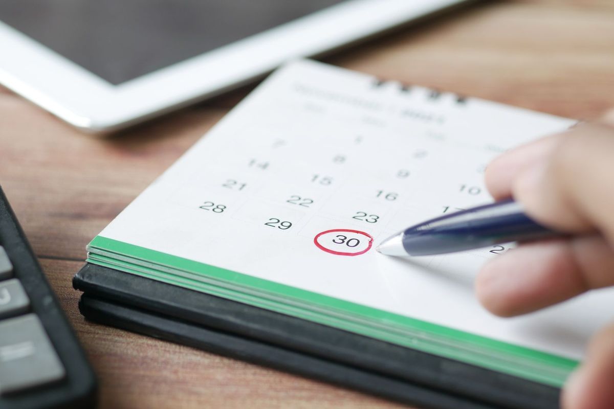 Pen circling the 30th on a desk calendar
