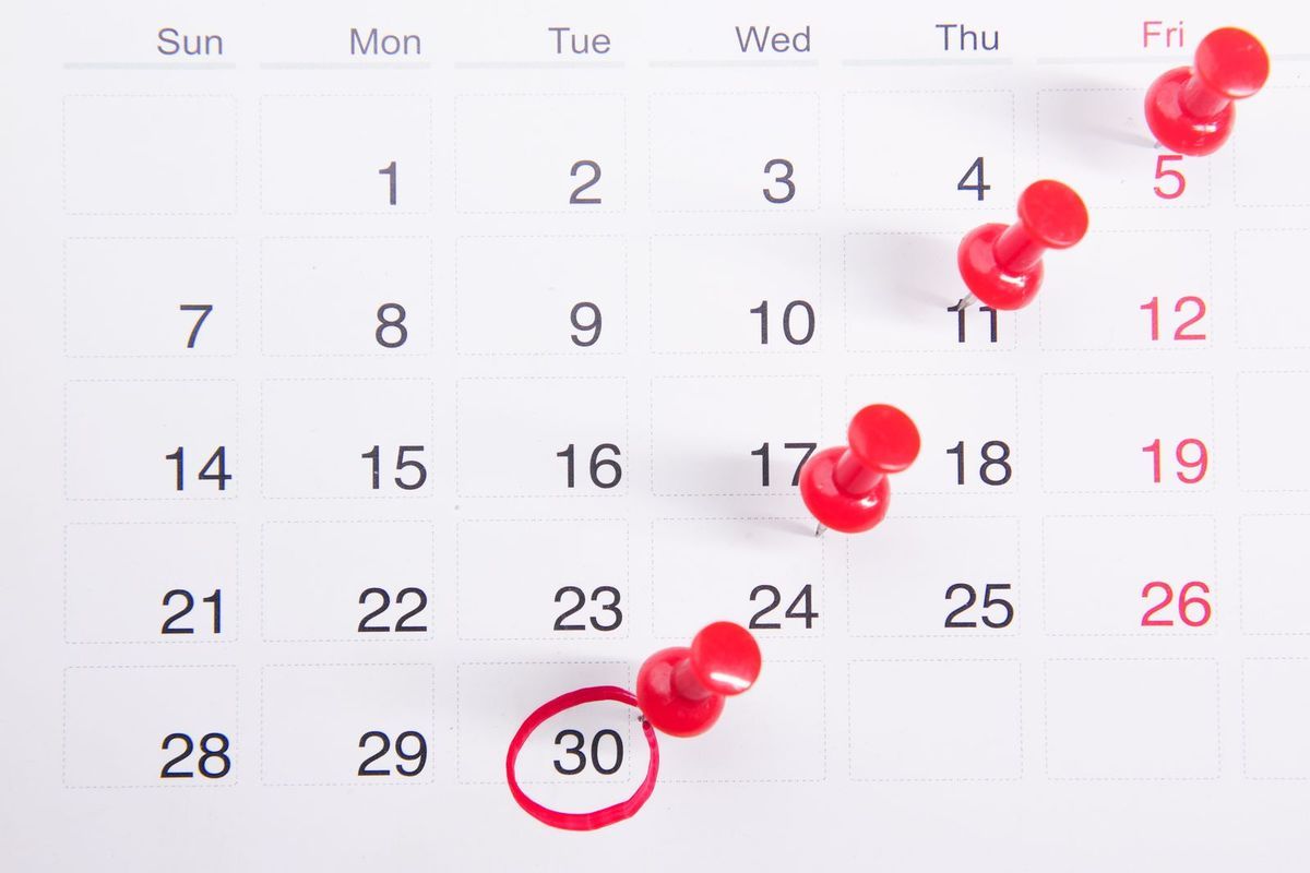Month calendar with red pins on several dates and the 30th circled