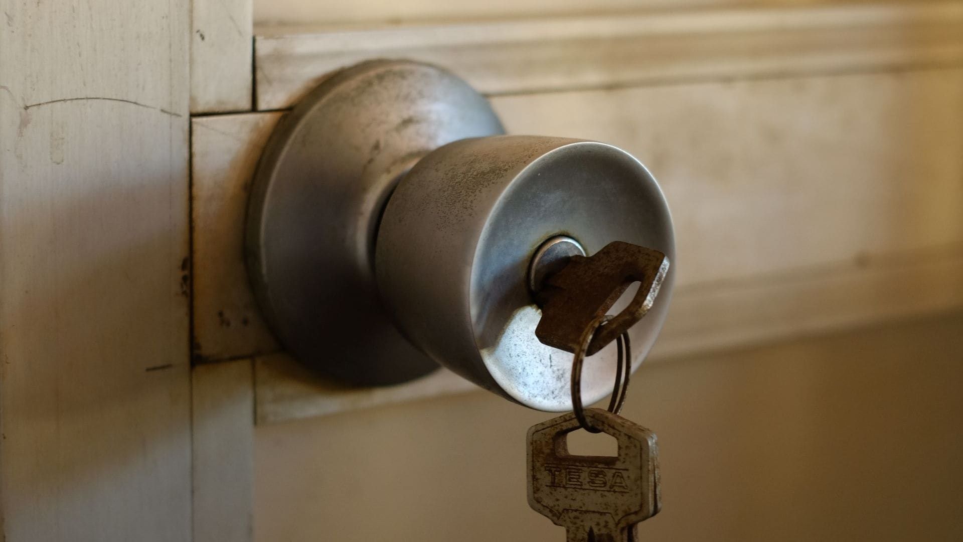 House key in the lock of a door knob