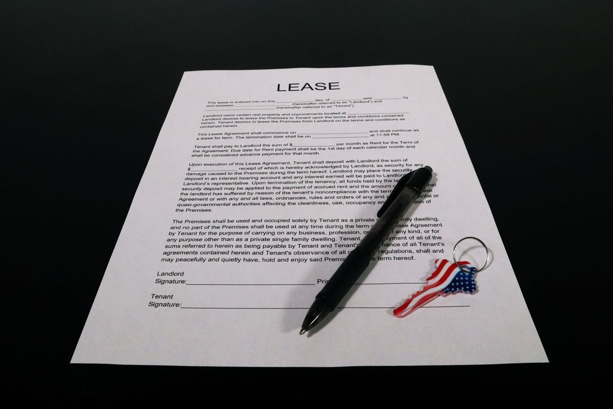 Residential lease form with a pen and a key chain