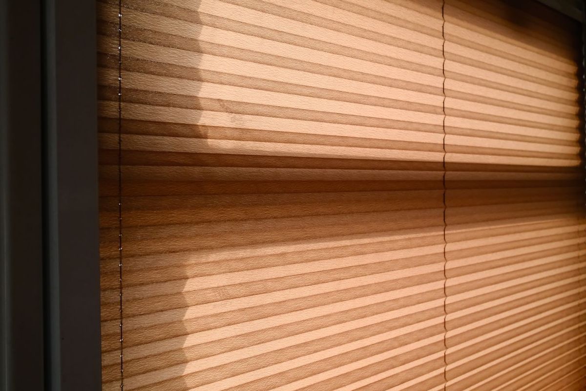 Hot afternoon sun shining through window blinds